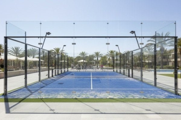Installing artificial turf on a padel court