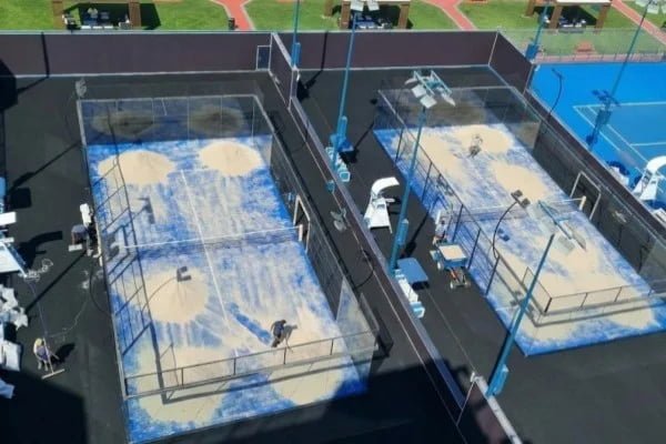 Close up of silica sand on blue artificial padel turf