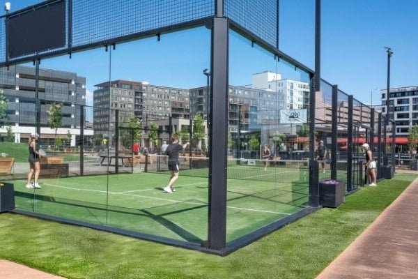 Outdoor padel court with welded mesh fence, steel frame, and artificial turf