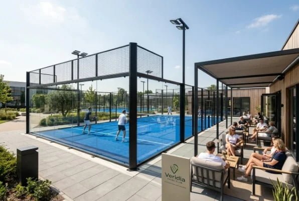 Modern padel court next to clubhouse seating area