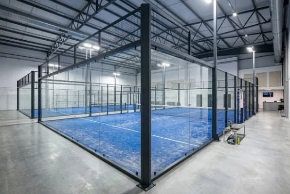 Indoor padel court system with glass walls and steel frame